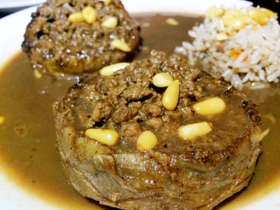 Artichoke stuffed with ground beef/lamb and topped with pine nuts